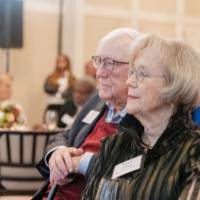 Don and Nancy Lubbers sitting together and looking up at stage